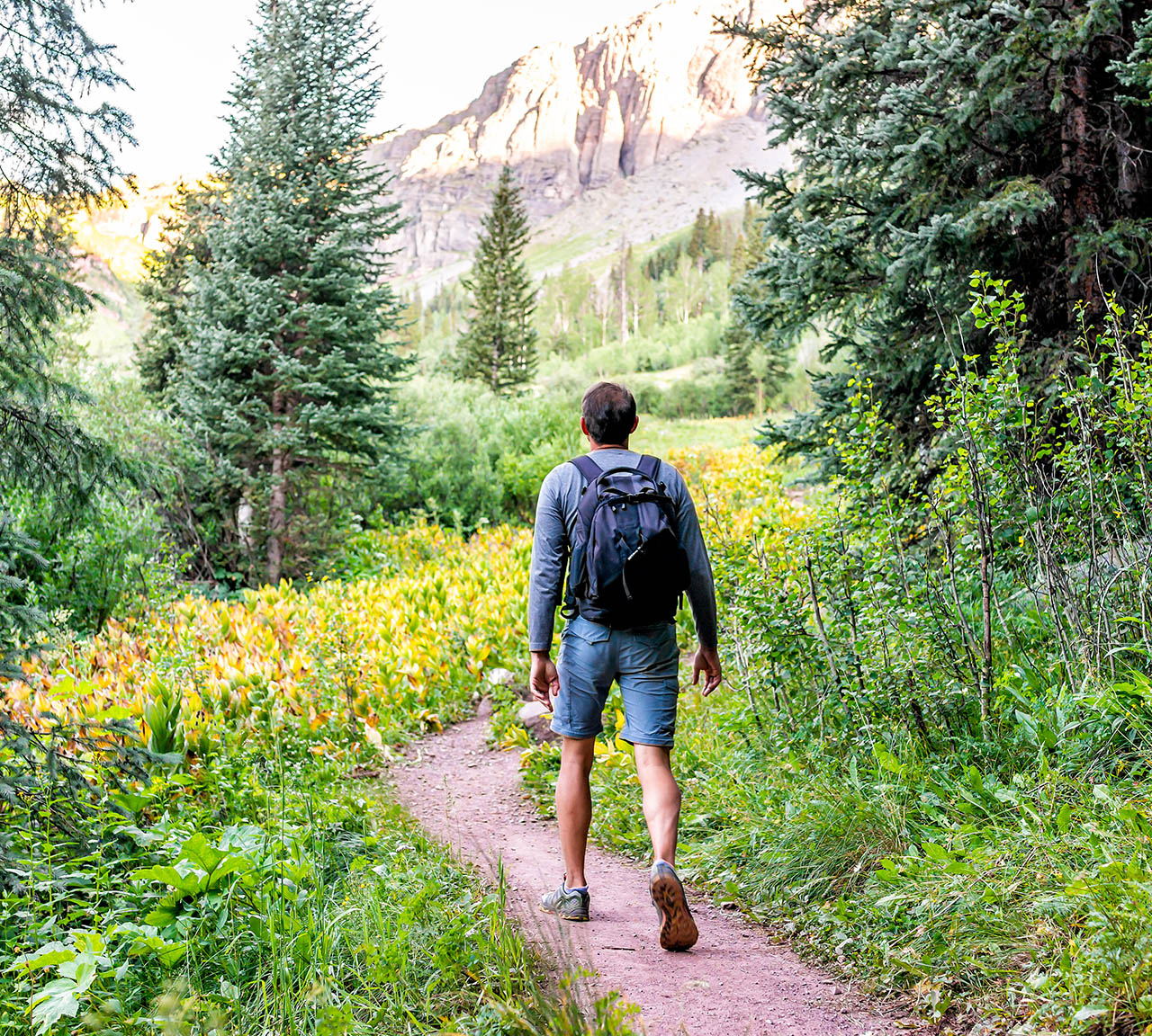 thumb-home-hiking A man enjoying a hike through the beautiful Grand Targhee Resort grounds on the western side of the Tetons
